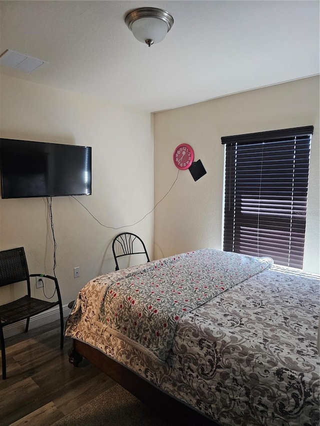 bedroom with visible vents and wood finished floors