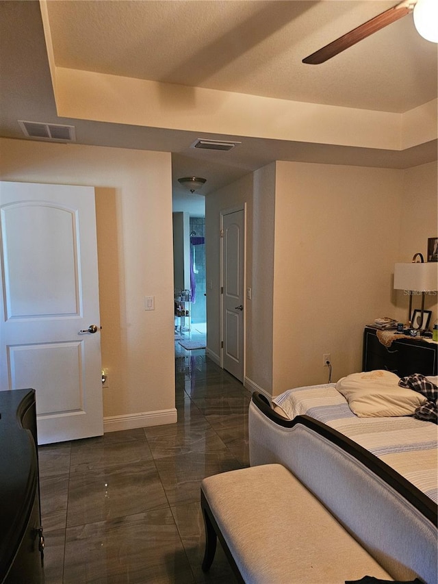 bedroom featuring visible vents, baseboards, and a ceiling fan