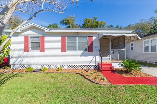 view of front of home with covered porch and a front yard