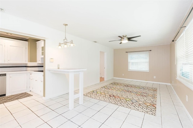 spare room featuring visible vents, ceiling fan with notable chandelier, a wealth of natural light, and light tile patterned flooring