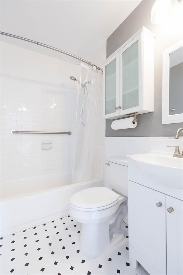 bathroom featuring shower / tub combo, vanity, and toilet