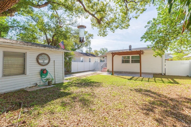 view of yard with entry steps and fence