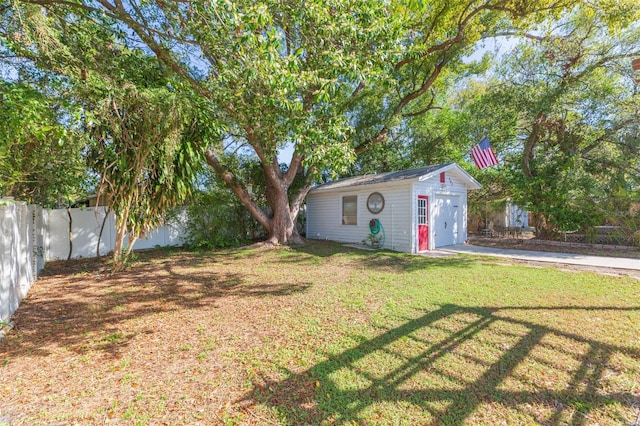 view of yard with fence and an outdoor structure