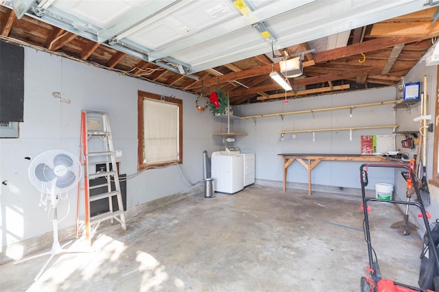 garage with a garage door opener and washing machine and dryer