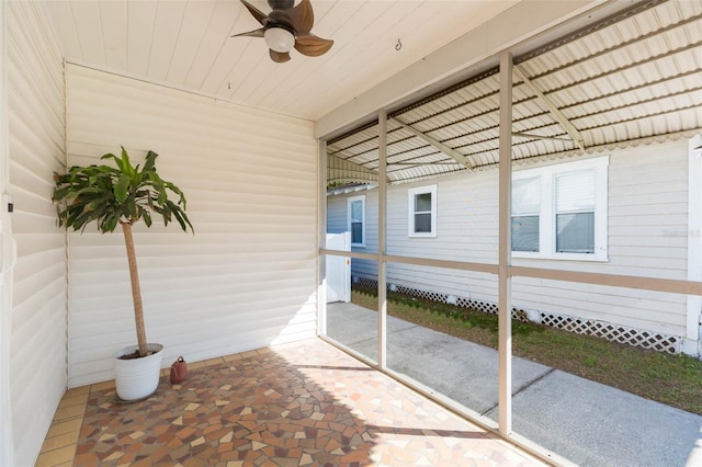 sunroom featuring wood ceiling and ceiling fan