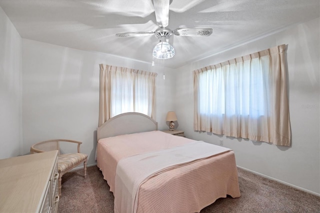 bedroom featuring multiple windows, carpet, and ceiling fan