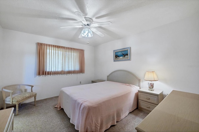 bedroom with a ceiling fan and carpet flooring