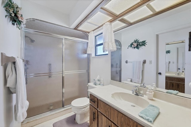 full bath featuring a shower stall, toilet, and vanity