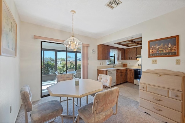 dining space with a notable chandelier, light tile patterned flooring, and visible vents