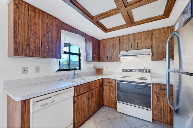 kitchen with extractor fan, light countertops, light tile patterned floors, white appliances, and a sink