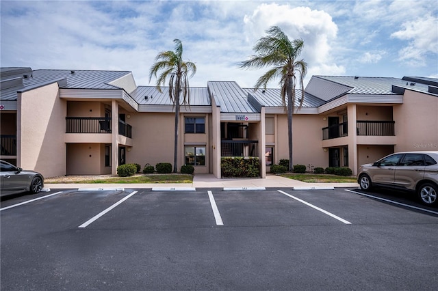 view of building exterior with uncovered parking