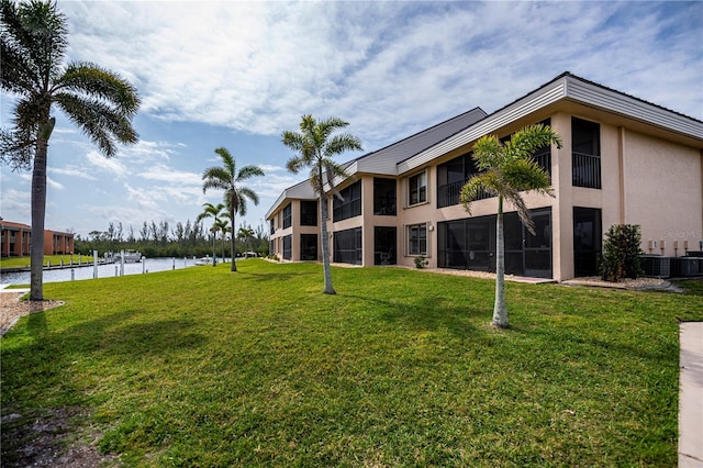 view of property featuring cooling unit and a water view