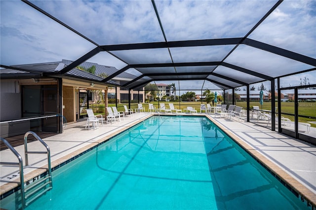 community pool featuring a patio and glass enclosure