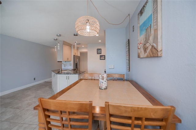 dining area featuring light tile patterned floors, recessed lighting, baseboards, and an inviting chandelier