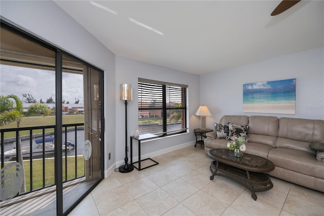 living area with baseboards and light tile patterned floors