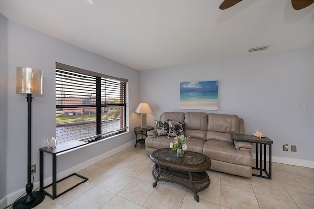 living room with light tile patterned floors, baseboards, visible vents, and a ceiling fan