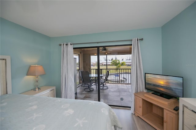 bedroom featuring access to outside and wood finished floors