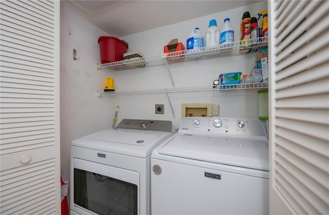 clothes washing area with washing machine and dryer and laundry area