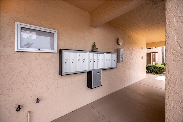 exterior space with mail area and stucco siding