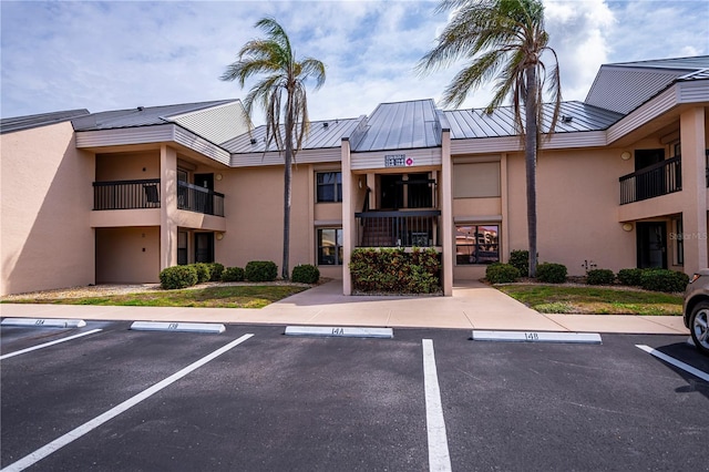 view of building exterior with uncovered parking