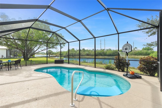 pool featuring a water view, glass enclosure, and a patio