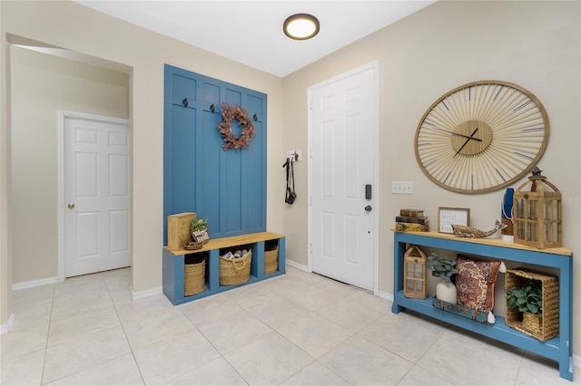 entryway featuring light tile patterned floors and baseboards