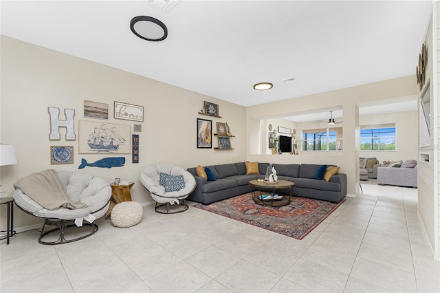 living room featuring light tile patterned flooring and baseboards