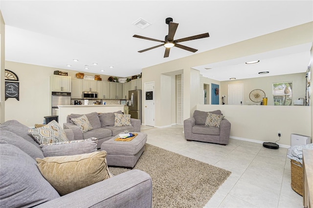 living room featuring baseboards, visible vents, a ceiling fan, light tile patterned flooring, and recessed lighting