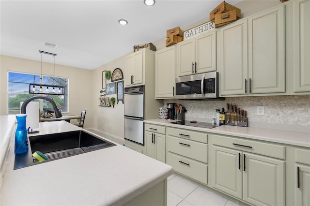 kitchen with black electric stovetop, double wall oven, a sink, visible vents, and stainless steel microwave