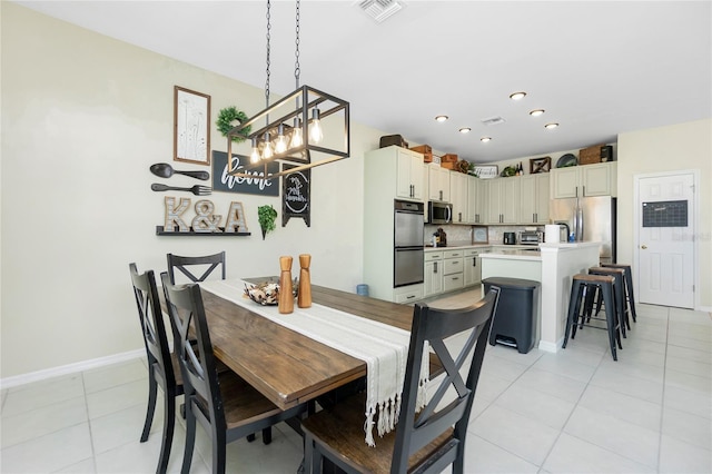 dining area with light tile patterned floors, baseboards, visible vents, and recessed lighting