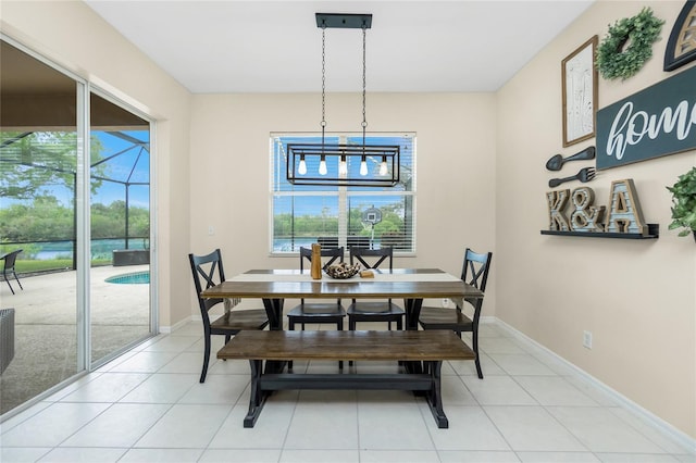 dining space featuring a wealth of natural light, light tile patterned flooring, and baseboards