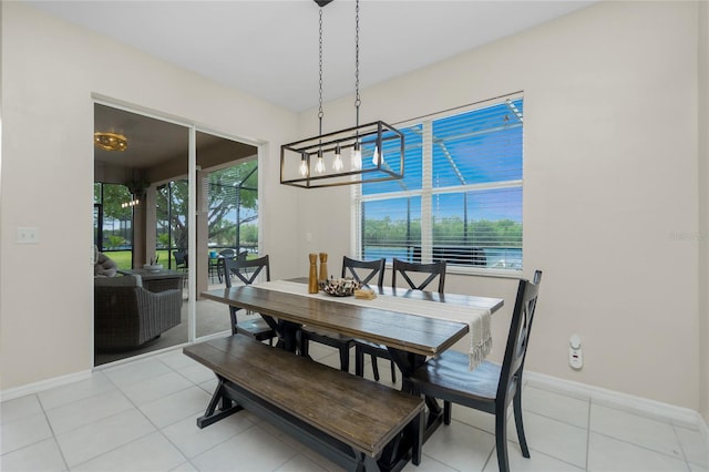 dining space with light tile patterned floors, baseboards, and a wealth of natural light