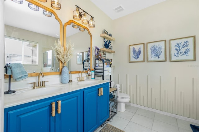 full bathroom with double vanity, a sink, visible vents, and tile patterned floors