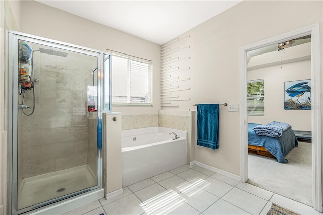 bathroom featuring a stall shower, a bath, and tile patterned floors