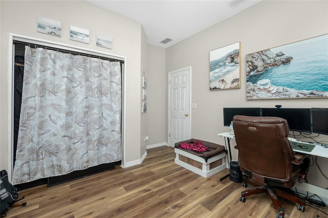 office with wood finished floors, visible vents, and baseboards