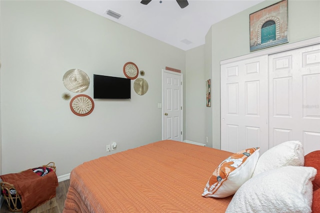 bedroom featuring a closet, visible vents, ceiling fan, wood finished floors, and baseboards