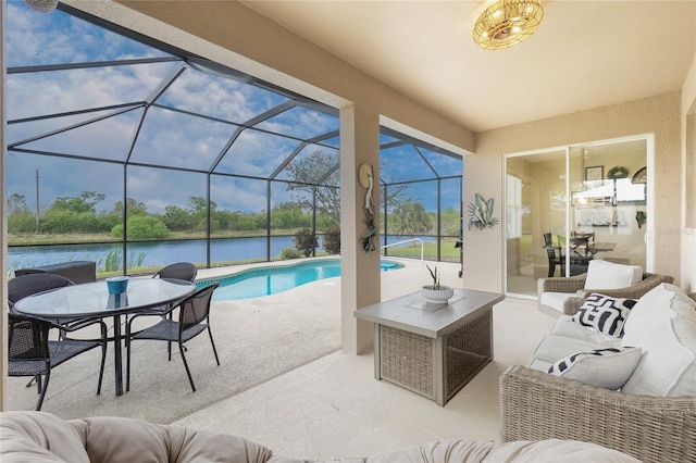 outdoor pool featuring a patio area, glass enclosure, a water view, and an outdoor living space