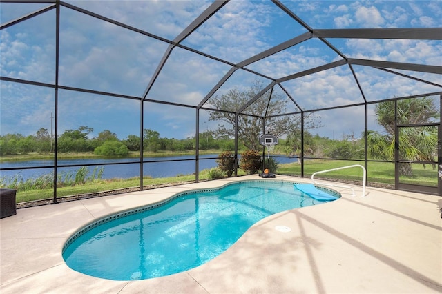 pool with glass enclosure, a water view, and a patio