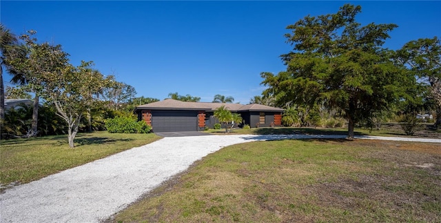 view of front of property with driveway, a front lawn, and an attached garage