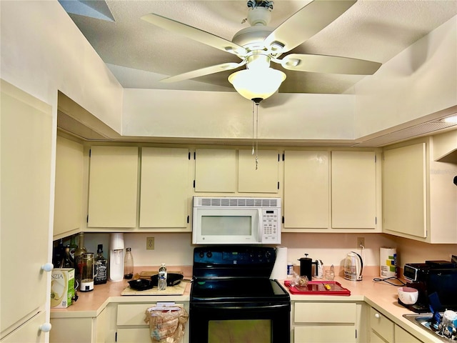 kitchen with light countertops, white microwave, ceiling fan, a sink, and black range with electric cooktop