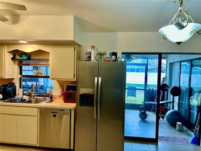 kitchen with stainless steel appliances, light countertops, a sink, and white cabinetry