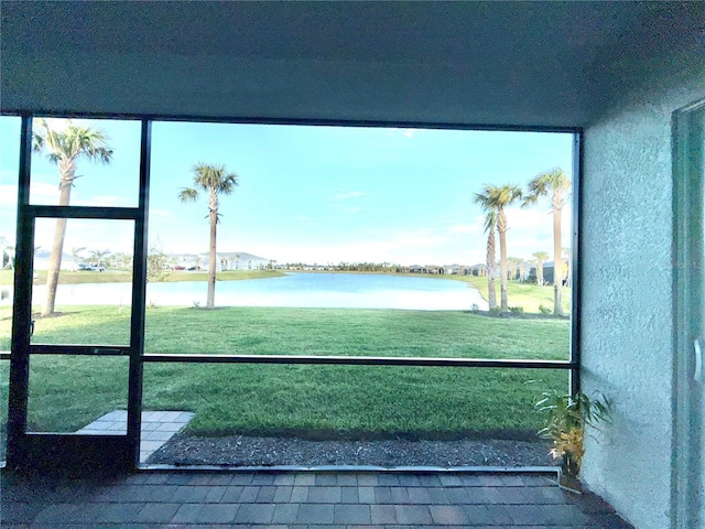 unfurnished sunroom with a water view