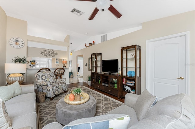 living area featuring a ceiling fan, lofted ceiling, and visible vents