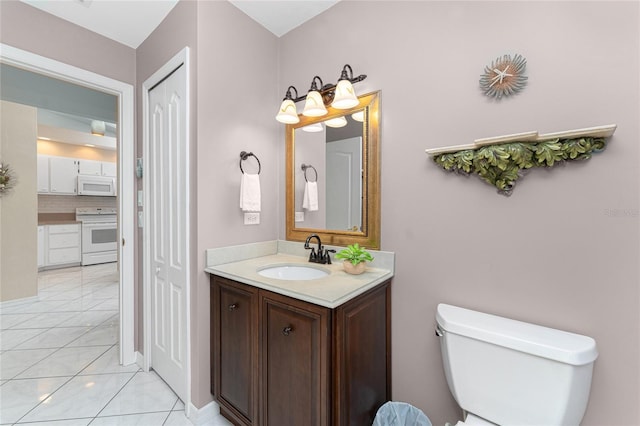 bathroom with toilet, tile patterned flooring, backsplash, and vanity