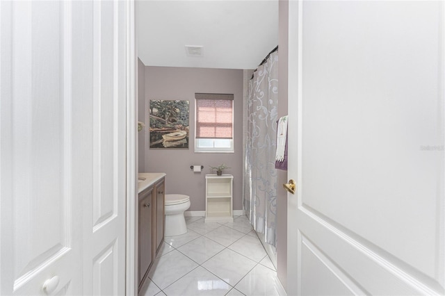 bathroom with visible vents, toilet, vanity, tile patterned flooring, and baseboards