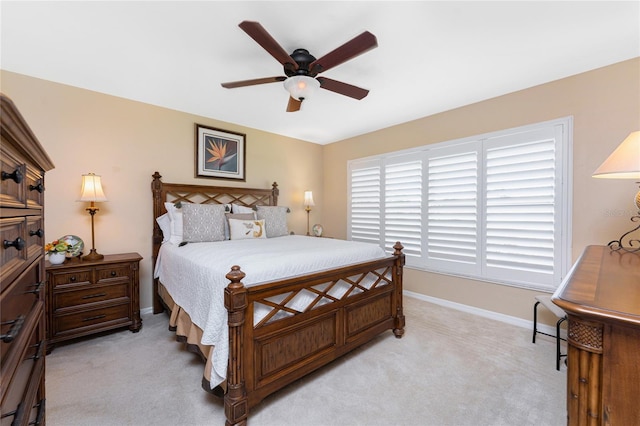 bedroom with light carpet, a ceiling fan, and baseboards