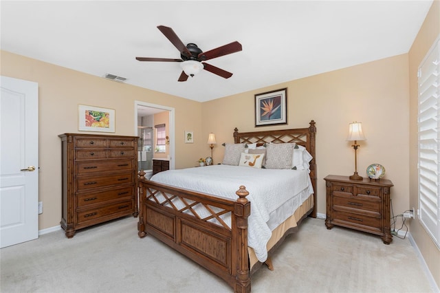 bedroom featuring baseboards, light carpet, ceiling fan, and ensuite bath