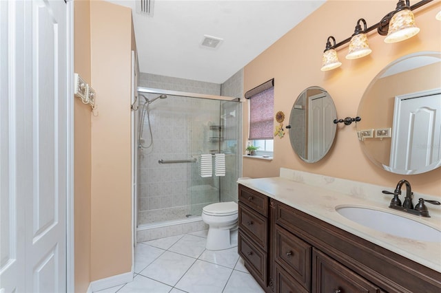 bathroom featuring toilet, a stall shower, visible vents, and vanity