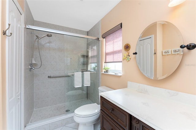 bathroom with a stall shower, vanity, and toilet