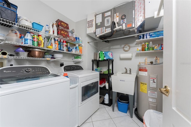 laundry room with water heater, laundry area, tile patterned flooring, and washing machine and clothes dryer